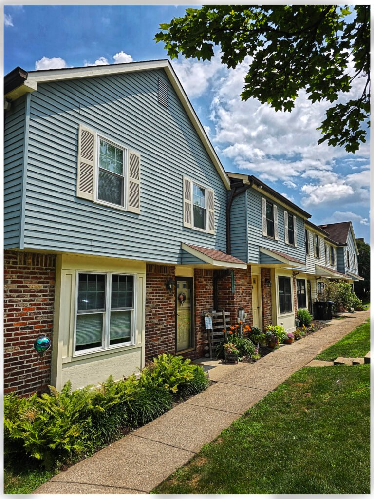 Blue vinyl siding townhome exterior with brick base, Ross Township PA
