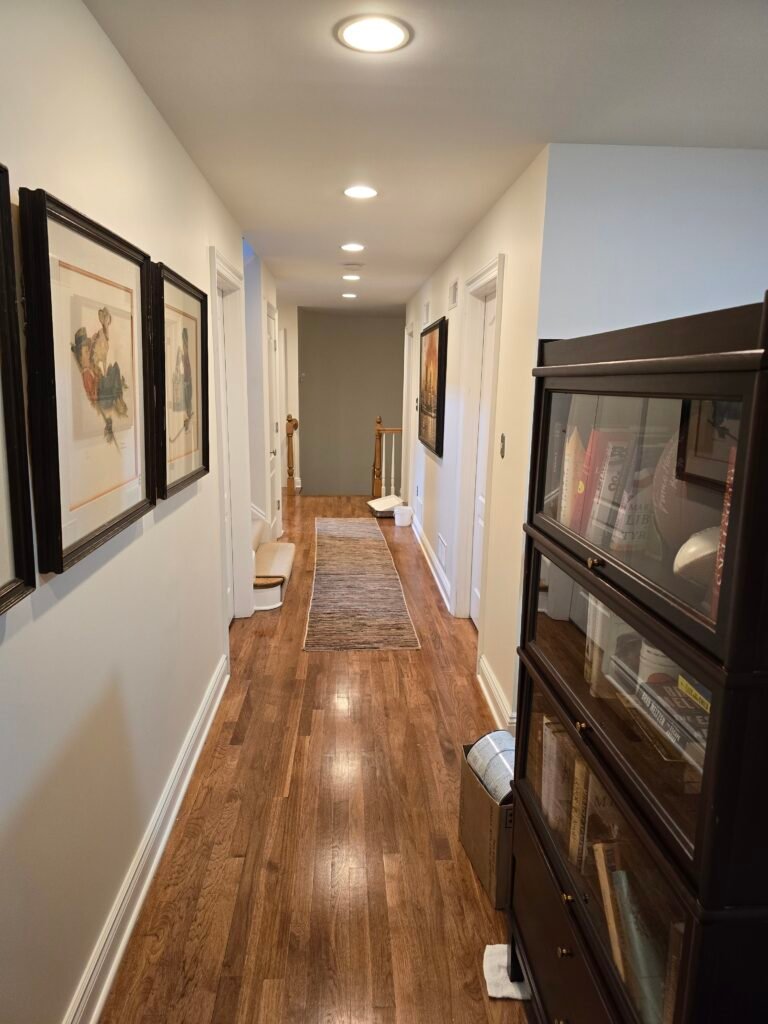 Hallway mid-painting with wood flooring and gallery wall, Oakmont PA