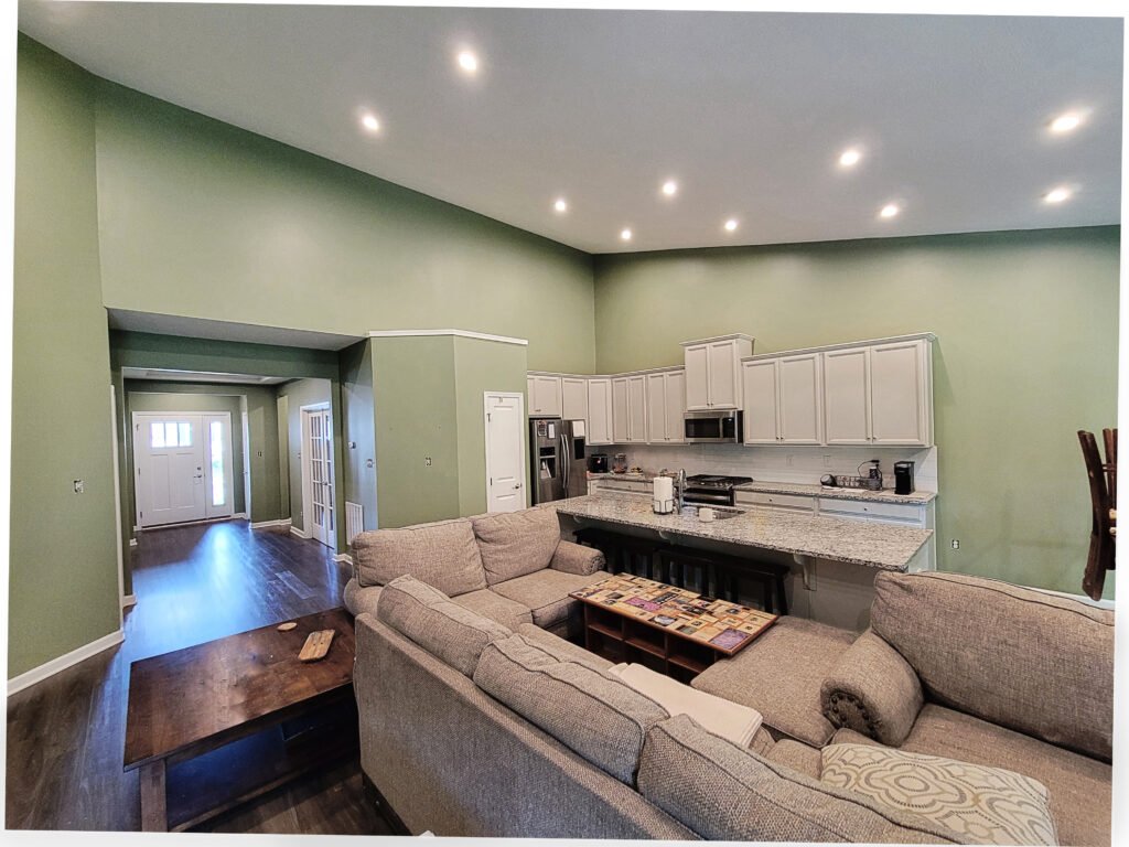 Open-concept living room and kitchen painted sage green, Mt. Lebanon PA